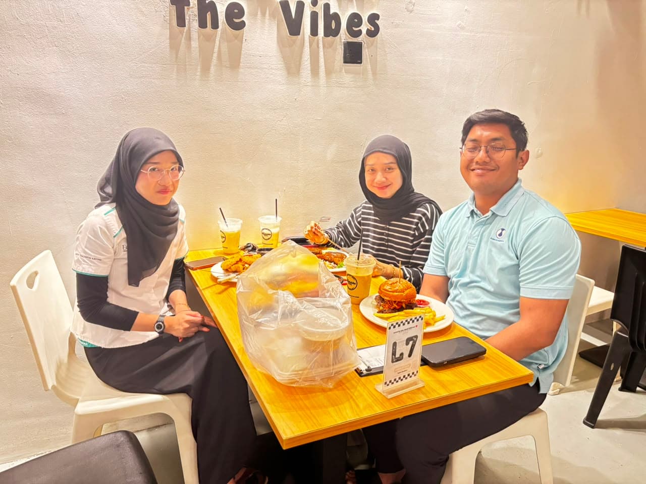 Friends enjoying burgers together at The Roadside Eatery